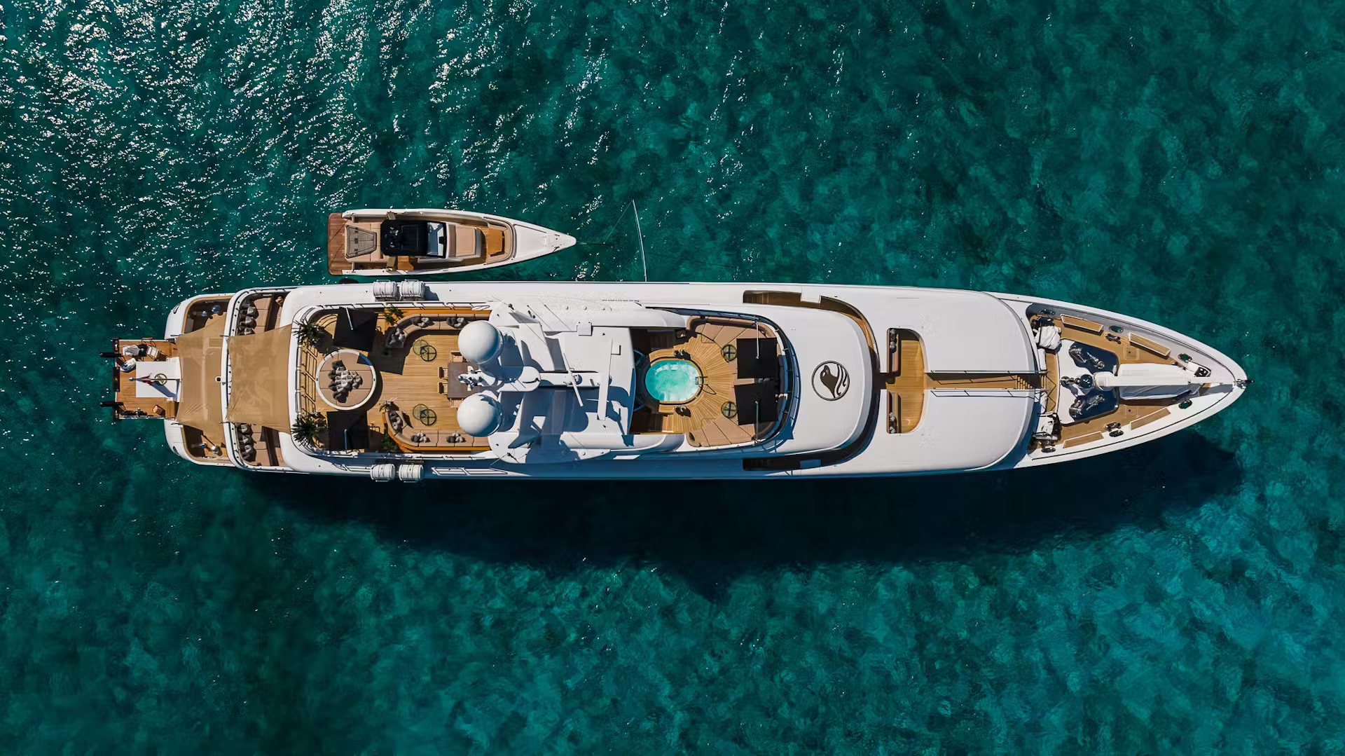 Tender speedboat skimming ocean swells with deployed canopy