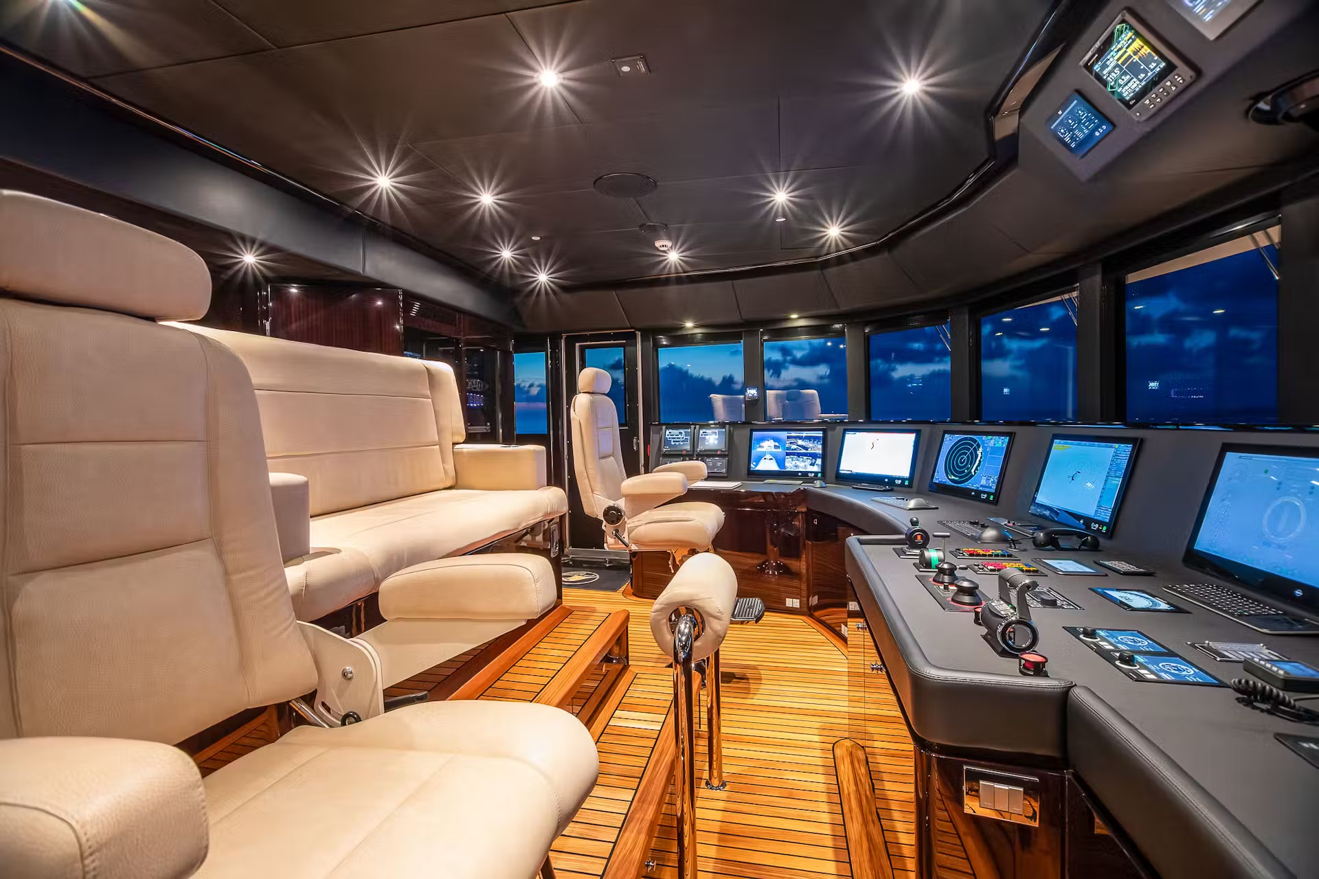 Yacht wheelhouse interior with cream leather seating and navigation displays