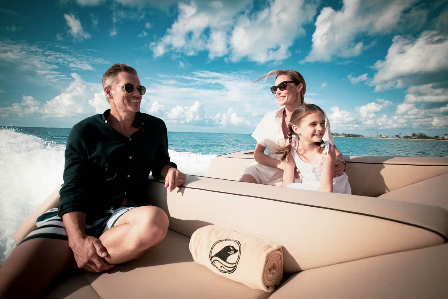 Family of three in tender approaching turquoise shore waters