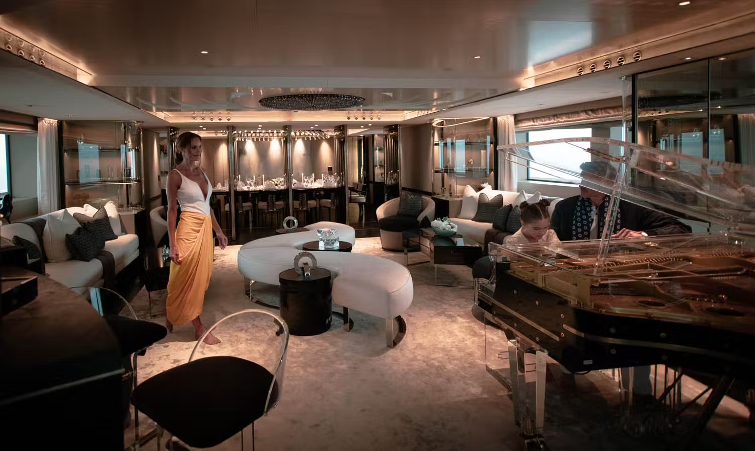 Owner's entertainment suite with blue-lit circular ceiling, family sofa seating and ocean panorama.