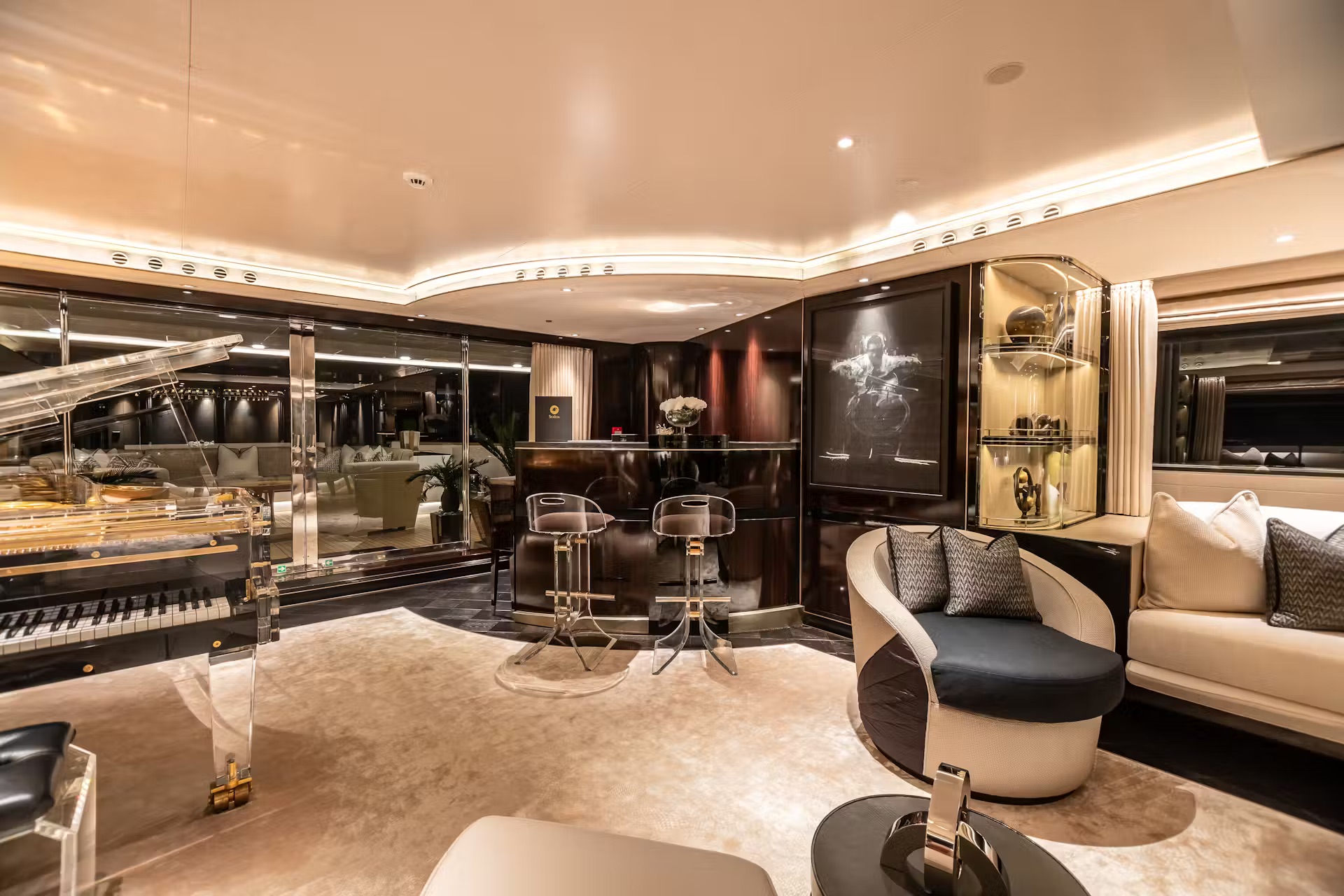 Expansive owner's saloon with panoramic ocean views, blue neon ceiling detail and luxury seating.