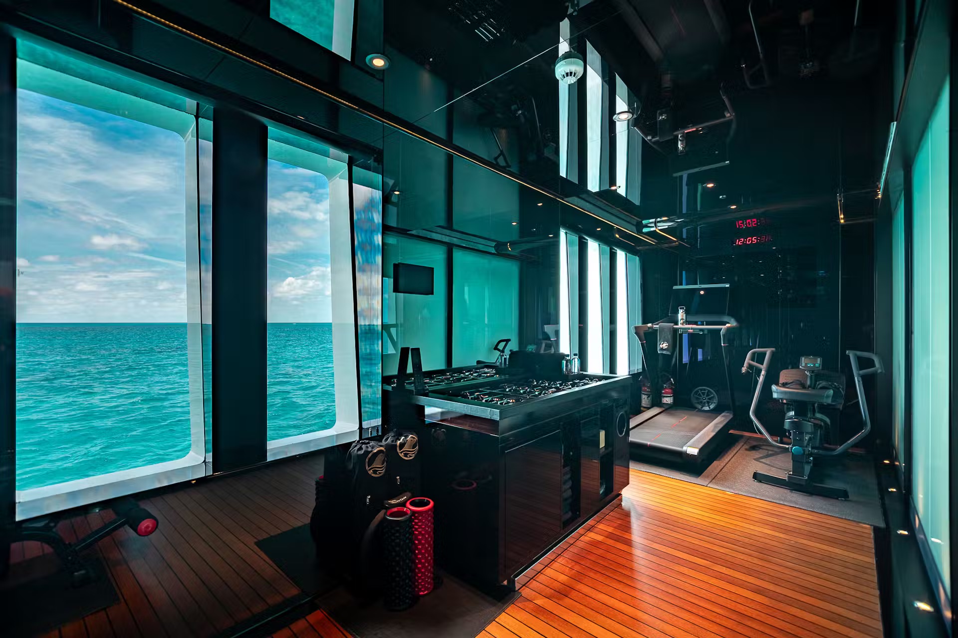 Fitness room with foosball table, exercise equipment, and transparent sea views